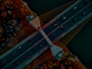 Beautiful panoramic aerial drone view to cable-stayed Siekierkowski Bridge over the Vistula river and Warsaw City skyscrapers, Poland in gold red autumn colors in November evening at sunset - top down